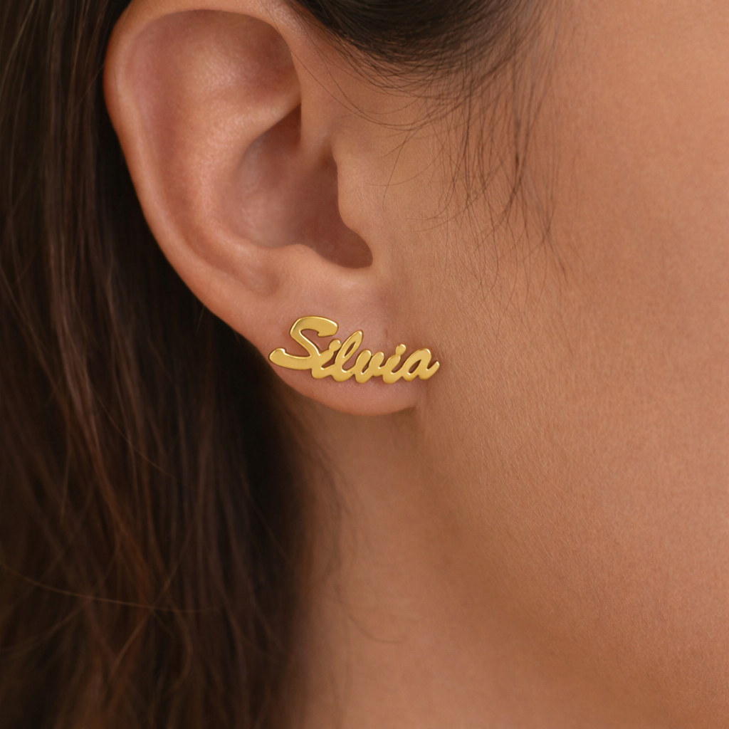 Gold 'Silvia' earring on a person's ear